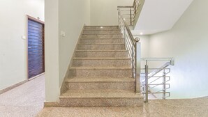 A staircase with granite steps and metal railings, leading to an upper floor. - Hotel Shivansh (Jaipur)