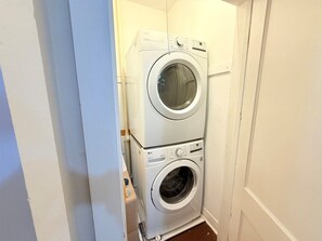A laundry room with two stacked washing machines. - Stylish Abilene Home - Berry Suites (Abilene)