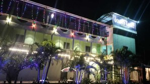 A hotel with a sign reading "GOLDEN GATE" and a well-lit exterior with string lights. - Hotel Golden Galaxy (Mahabaleshwar)