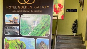 A Hotel Golden Galaxy sign with a staircase and a room number sign. - Hotel Golden Galaxy (Mahabaleshwar)