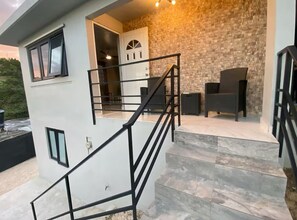 A modern building with a staircase leading to a balcony.