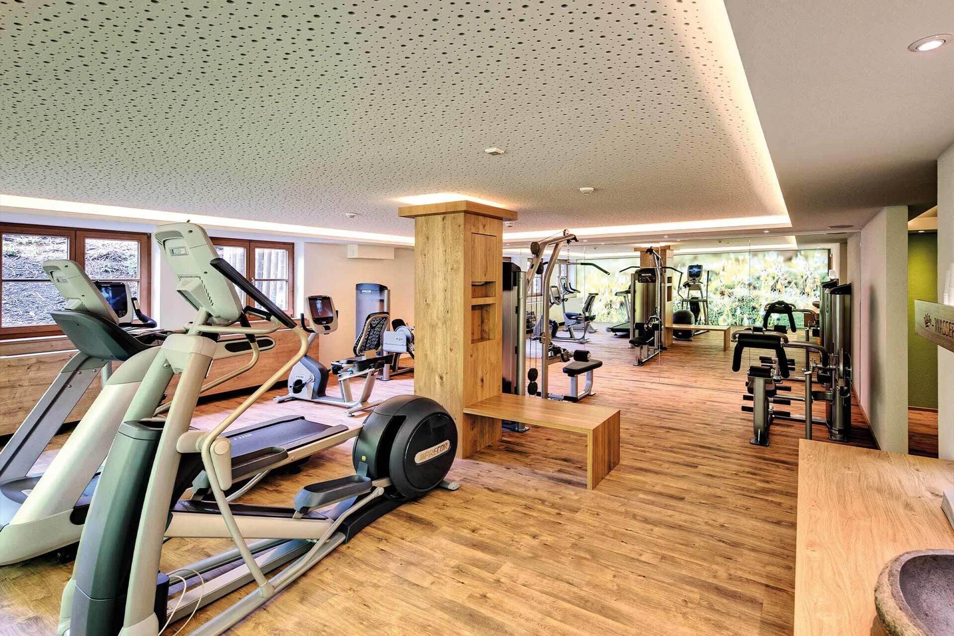 A gym with treadmills, ellipticals, and weight machines.