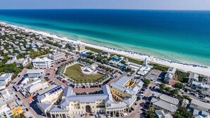 An aerial view of a coastal town with a central plaza, beachfront, and residential buildings. - Stunning New Main & Carriage House w/ Private Pool- Seas the Day of Seagrove (Santa Rosa Beach)