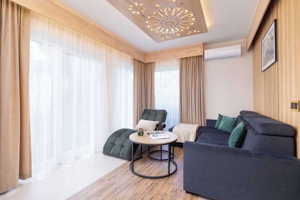 Lounge area with soft sofa, coffee table and chaise longue.