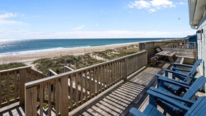 A wooden deck with a view of the beach and ocean. - Classic Oceanfront Beach Cottage! (Emerald Isle)