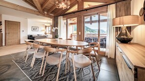 A spacious dining area with a wooden table and chairs, large windows, and a view of the outdoors. - Ardelle - alpine duplex with hot tub, Les Gets (Les Gets)