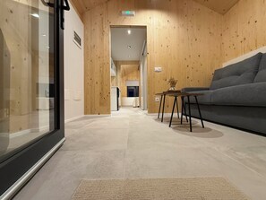 Cabaña Deluxe, balcón, vista al mar | Área de sala de estar