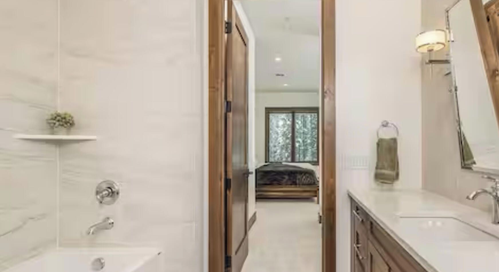A modern bathroom with a shower, sink, and mirror.