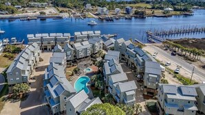A coastal residential area with modern buildings, a marina, and a swimming pool. - Affordable Waterfront Luxury!  "Jewel of Carrabelle" Perfect Condo on the Cove! (Carrabelle)