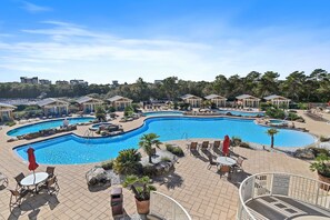 A large outdoor swimming pool with multiple sections and surrounding lounge areas. - Sanctuary at Redfish Luxury Complex/4 Bedroom Unit/Sleeps 10/Prvt Beach Access! (Santa Rosa Beach)