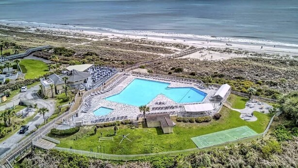 An aerial view of a resort with a large pool, a tennis court, and a beach. - Coastal Escape w/ Pool & Ocean Peek! (Hilton Head Island)
