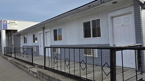 A motor inn with numbered rooms, a Pepsi sign, and a cold beer store. - Roblin Motor In (Roblin)