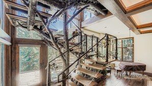 A wooden staircase with a natural design, leading to a balcony with a view of trees. - Immaculate Golf Course Home, Private Hot Tub, Gym, Firepits (Beaver Creek)