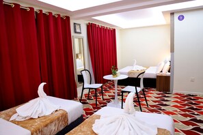 Standard Quadruple Room, City View | Desk, laptop workspace, soundproofing, iron/ironing board - Tanha Park Hotel (Dubai)