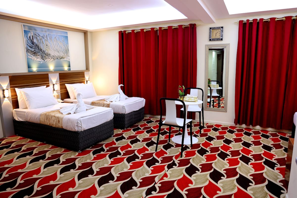 Standard Quadruple Room, City View | Desk, laptop workspace, soundproofing, iron/ironing board