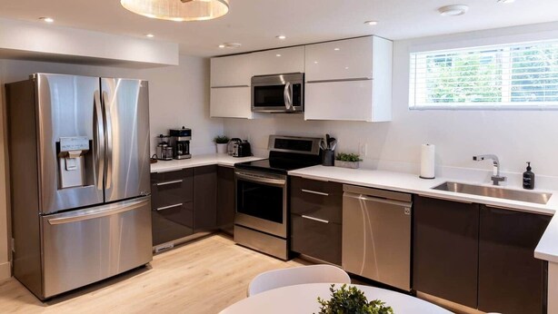 A modern kitchen with stainless steel appliances, a built-in oven, and a microwave.
