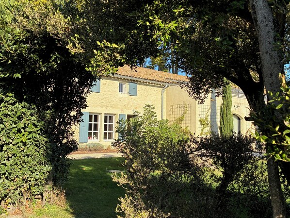 A house with a tiled roof, a visible window, and a pathway leading to the entrance. - Drôme Provençale Detached house in 18th century property, tennis access (Pierrelatte)