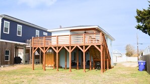 A house with a wooden deck and a covered porch.