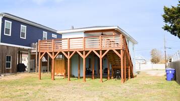 A house with a wooden deck and a covered porch.