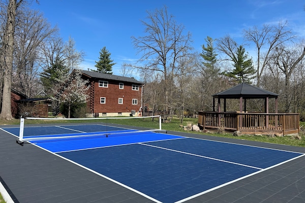 Private onsite regulation size pickleball court with Sport Court surface.