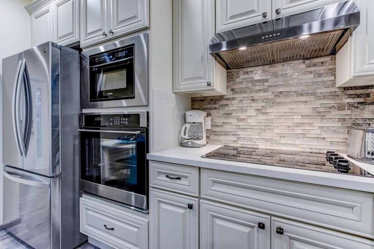 A modern kitchen with stainless steel appliances, a microwave, and a built-in oven.