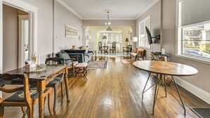 A spacious living room with a wooden dining table, comfortable seating, and a chandelier. - 2 Mi to Ybor City: Eclectic Tampa Charmer! (Tampa)