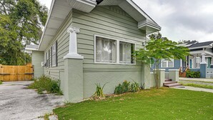 A residential house with a front yard, a wooden fence, and a driveway. - 2 Mi to Ybor City: Eclectic Tampa Charmer! (Tampa)
