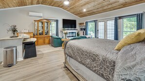 A bedroom with a large bed, wooden ceiling, and a view of the outdoors through windows. - 6 Mi to Clarks Hill Lake: Quiet Couple's Retreat (Appling)