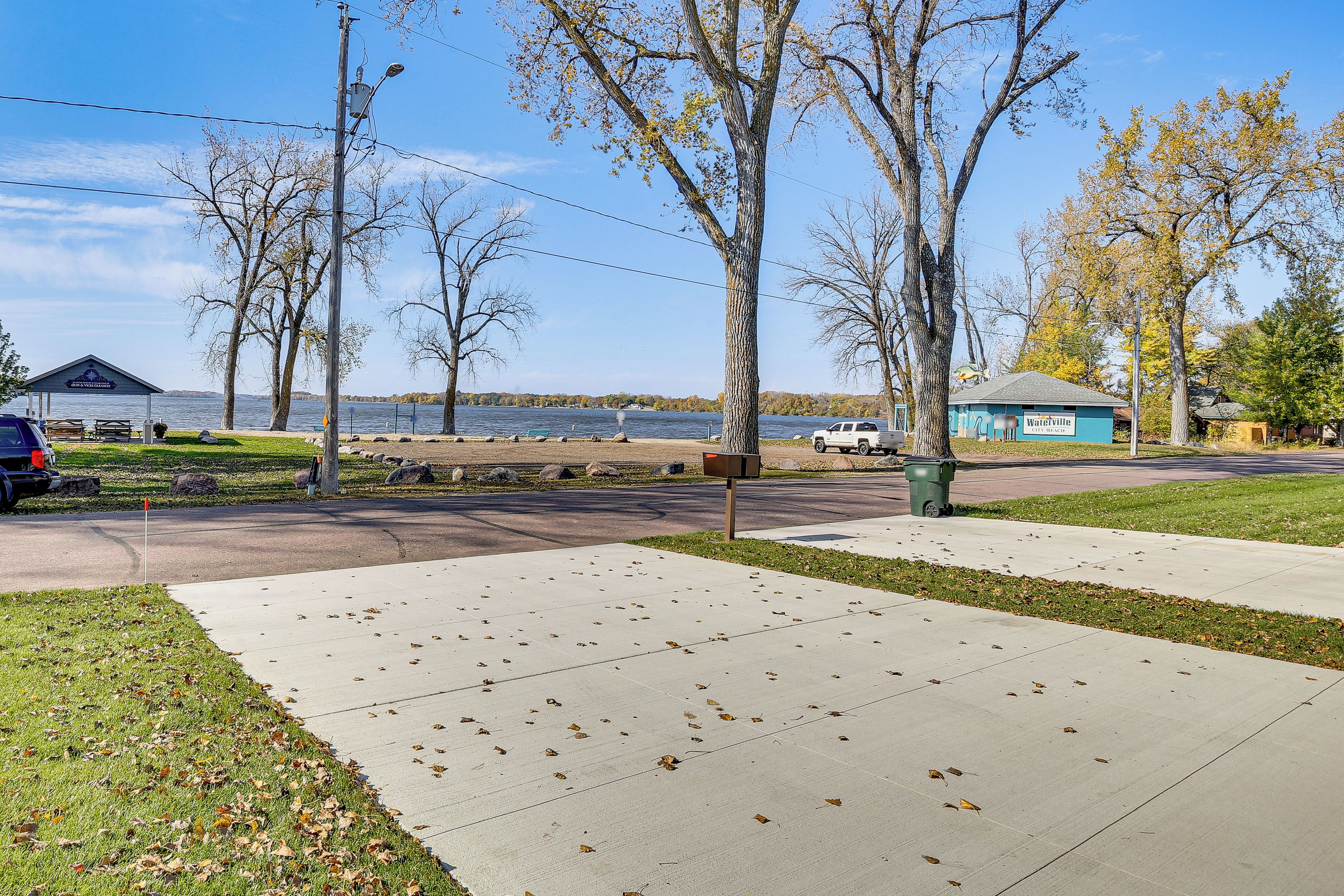 A lakeside park with picnic tables, a gazebo, and a blue building labeled 'Waterville City Beach.'