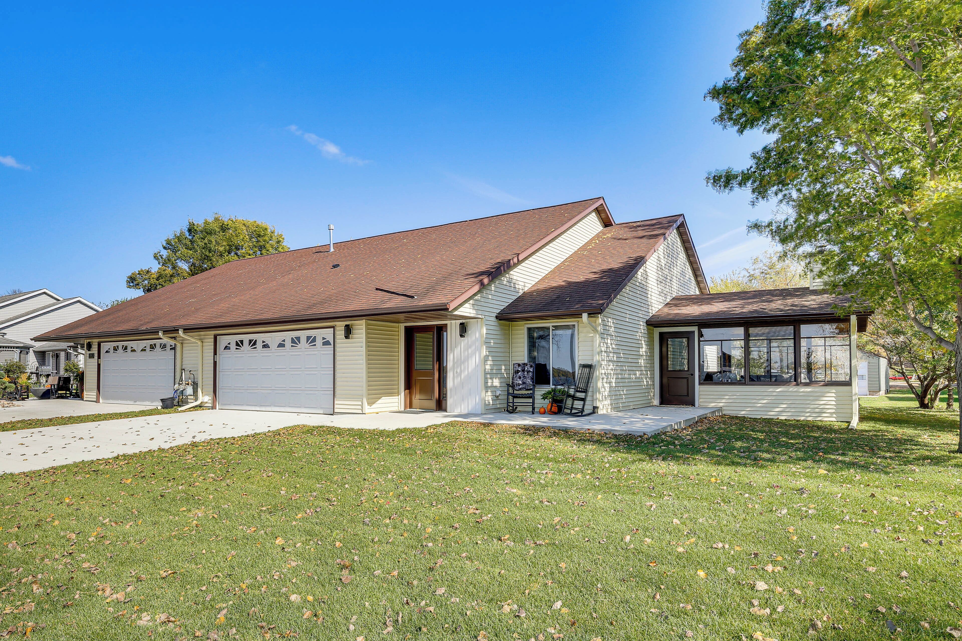 A single-story house with a garage, a front porch, and a well-maintained lawn.