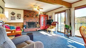 A cozy living room with a fireplace, comfortable seating, and a balcony with a view. - Relaxation Meets Upstate Adventure at Salem Home! (Salem)