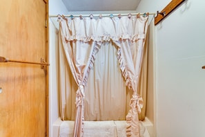 A bathroom with a wooden door, a shower curtain, and a towel rack. - Relaxation Meets Upstate Adventure at Salem Home! (Salem)