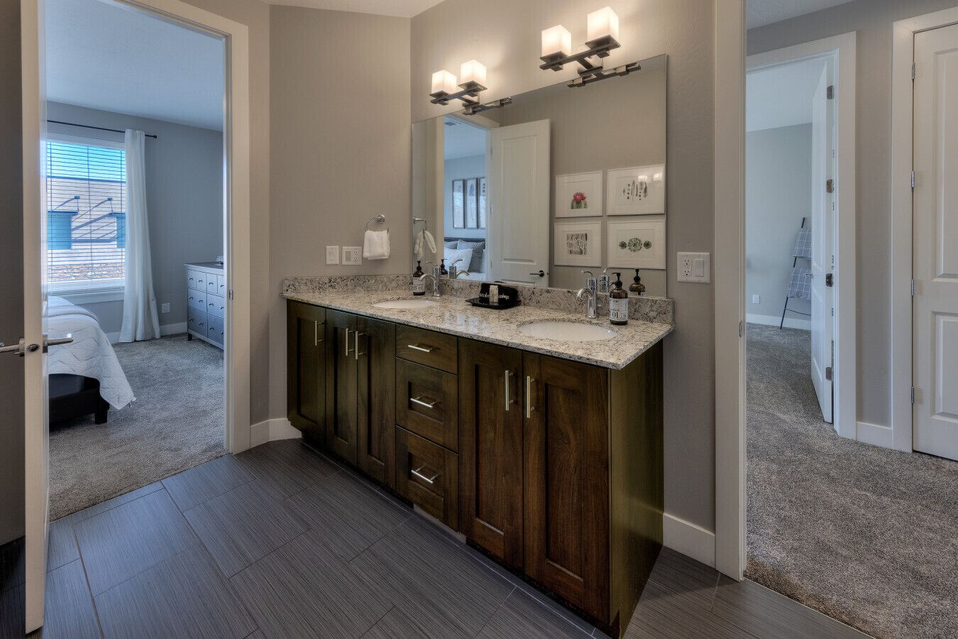 A modern bathroom with a large vanity, a mirror, and a shower area.