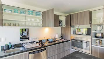 Een koelkast met diepvriezer, een microgolfoven, een oven, een kookplaat