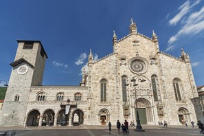 A historic building with a prominent clock tower and detailed stonework.