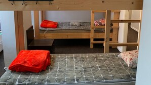 A bunk bed room with a wooden frame, a green towel, and a red blanket. - Artishalico tallinn (Tallinn)
