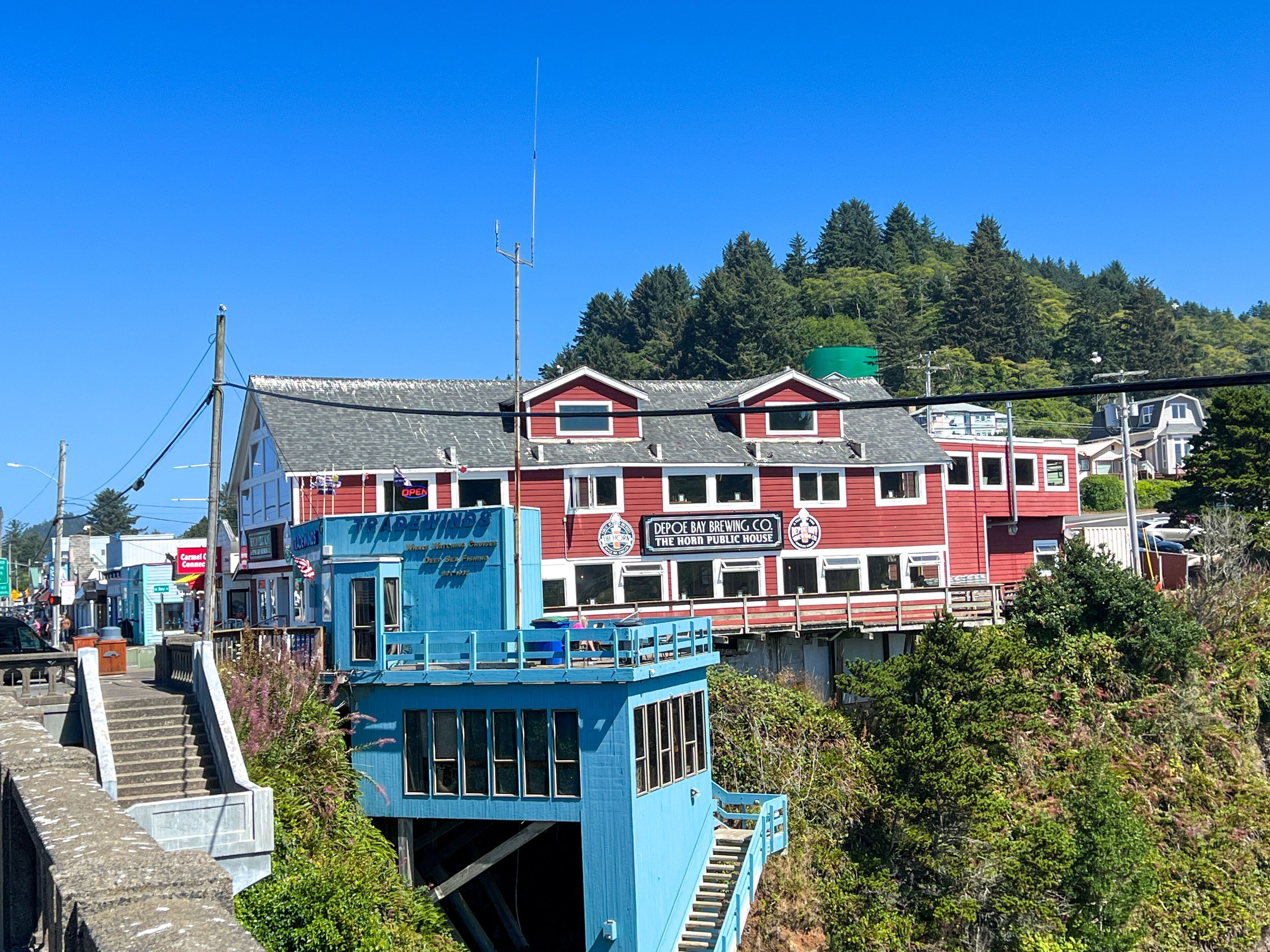 A red building with a blue tower, named 'The Horn Public House', featuring a staircase leading to the tower.