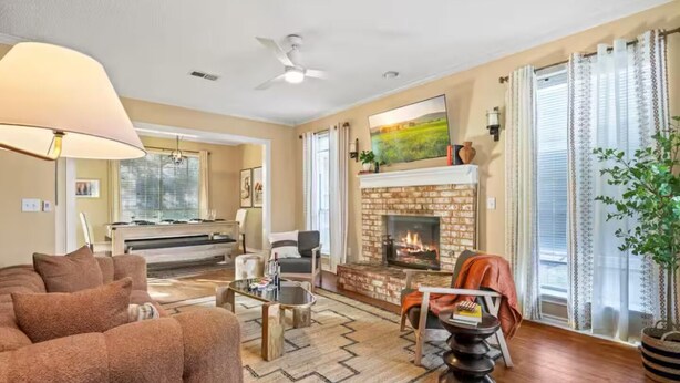 A spacious living room with a fireplace, a piano, and a large window with curtains. - 4BR Frisco Retreat Near Universal Kids Resort & Toyota + BBQ & Firepit (Frisco)