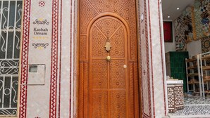 A traditional wooden door with intricate carvings, a tiled entrance, and a small balcony. - Kasbah Dream - Great Location in Tangier. (Tangier)