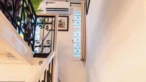 A staircase with patterned tiles, a black metal railing, and a potted plant. - Kasbah Dream - Great Location in Tangier. (Tangier)
