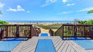 A wooden deck leading to a beach with a clear view of the ocean and sandy shore. - 2 Bedroom Condo with Ocean and Bay Views (Ocean City)