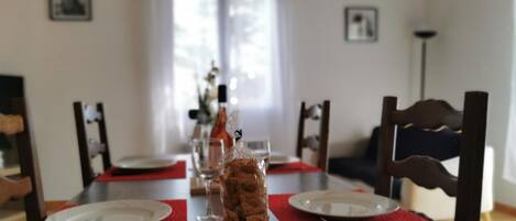 A dining table set with plates, cutlery, and a glass of water.