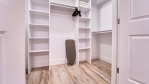 Un vestidor amplio con estantes y una barra para colgar.