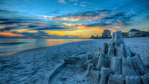 A beach with a large sandcastle structure in the foreground. - Vibe Out: Private beach steps away, Heated pool, Golfcart, Game room, Bunk rooms (Miramar Beach)