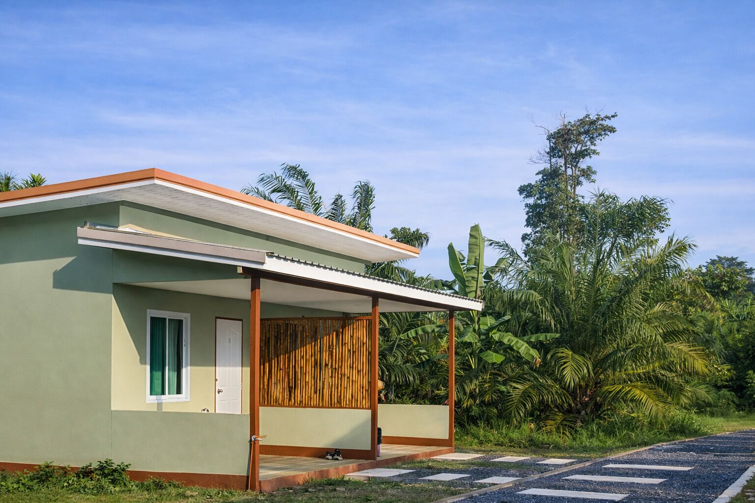 A small, single-story building with a flat roof and a covered porch area.