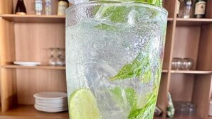 A tall glass with ice, lime slices, and mint leaves, likely containing a cold beverage. - Balangan Surf Resort (Jimbaran)