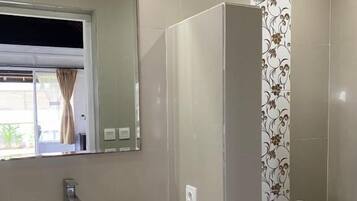 Een douche, handdoeken, zeep, shampoo