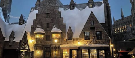 A stone building with multiple windows and a central tower, possibly a hotel or historic site.