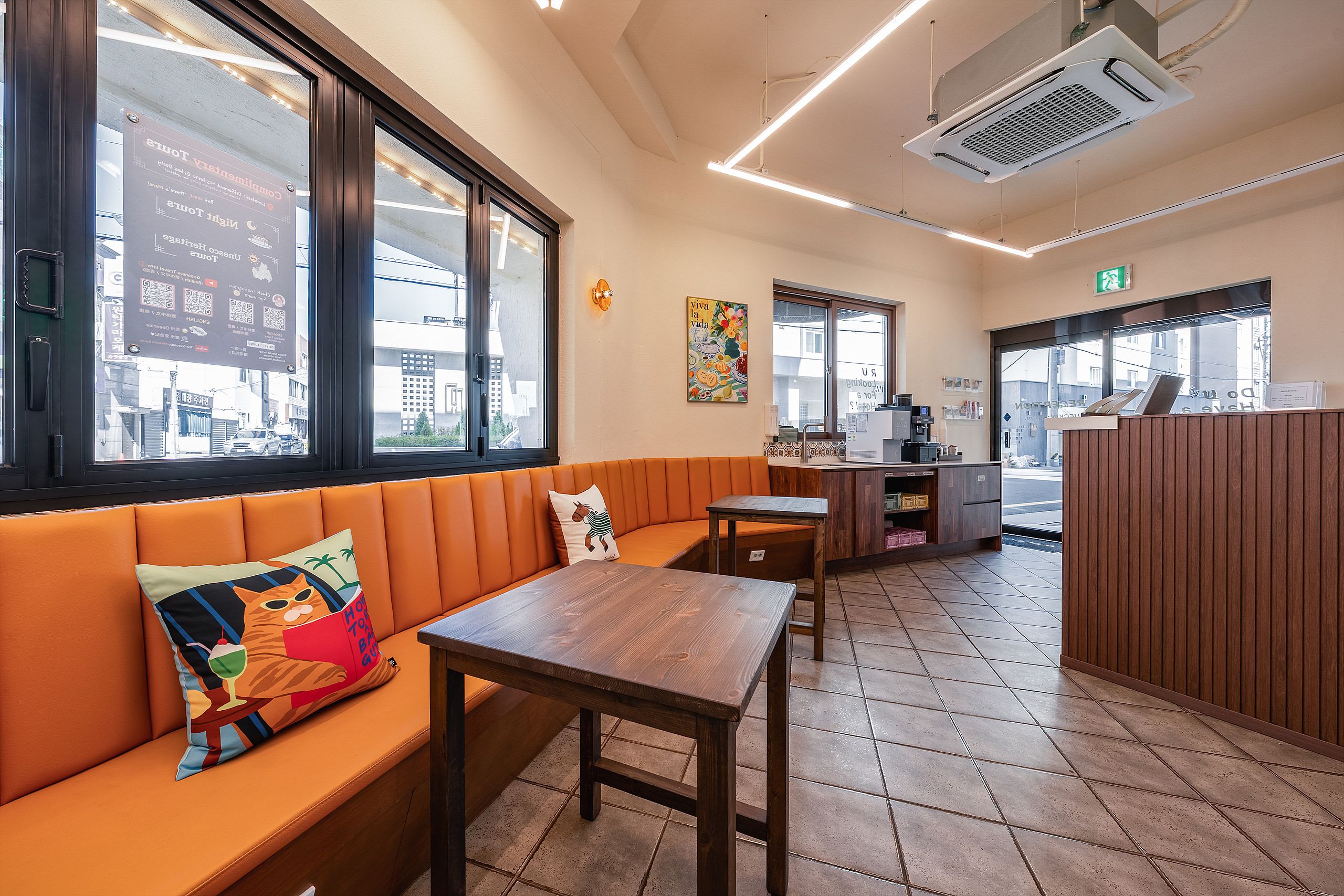 A restaurant interior with a wooden bench, a table, and a counter.