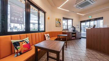 A restaurant interior with a wooden bench, a table, and a counter.